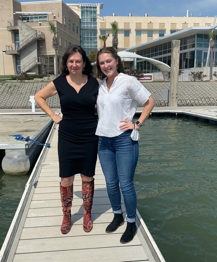 Dr. Quigg (left) and Ph.D. student Sarah Davis (right) are pictured on the TAMUG boat docks. In this area natural communities of phytoplankton are bottled and provide a basis for environmental assessment of PFOS. 